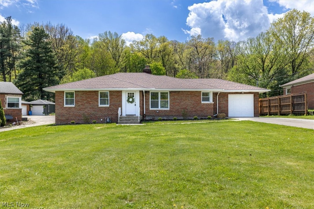 Welcome to 96 E Ridgewood Dr, where timeless construction meets thoughtful modern updates in the heart of Seven Hills. This beautifully maintained brick ranch immediately commands attention with its striking red brick exterior, brand-new roof, widened driveway, and impressive backyard transformation. A newly constructed A-frame covered patio extends your living space outdoors, overlooking more than an acre of scenic property—an exceptional setting for entertaining, relaxing, or simply enjoying the privacy and space that is rarely found. Step inside and experience a home that has been carefully reimagined for today’s lifestyle. The open-concept design creates a seamless flow between the main living areas, highlighted by an updated kitchen designed for both everyday functionality and gathering with family and friends. Renovations throughout include new windows, updated electrical, upgraded plumbing fixtures and components, and numerous cosmetic improvements that create a clean, polished feel from room to room. The lower level adds another dimension of living space, offering incredible versatility with the potential for a fourth bedroom, private home office, or guest suite. A spacious recreation area with a refurbished bar and full bath creates the perfect environment for hosting, game days, or multigenerational living. From its solid construction and extensive updates to its rare oversized lot, 96 E Ridgewood Dr delivers the space, character, and functionality today’s buyers have been waiting for.