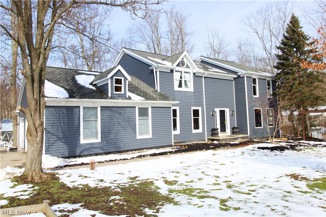 Highly sought-after Lake In The Woods neighborhood. 4 bedrooms 2.5 bath, 3 car side entry garage, center hall colonial. This lovely home features hard wood entry, open 2 story turned staircase, wonderfully large living room and family rooms with wood beamed ceiling in the living room. Updated center island kitchen with granite counter tops that complement the hard wood flooring. Live in harmony with nature with the bayed family room windows, fireplace and deck overlooking a heavily wooded back yard with your own private pond and barn. The upstairs loft leads to 3 additional bedrooms and a gorgeous well-appointed master suite. Reclaimed wood from a barn in Central Ohio was used in various aspects of the home including the railing and living room built-ins. New updates to the home include: siding (2018), AC/Furnace (2017), water softener(2015), well pump (2015), reclaimed lumber library(2017), deck (2015) basement doors(2018), new hardwoods in the first floor(2019), master bath (2018) an