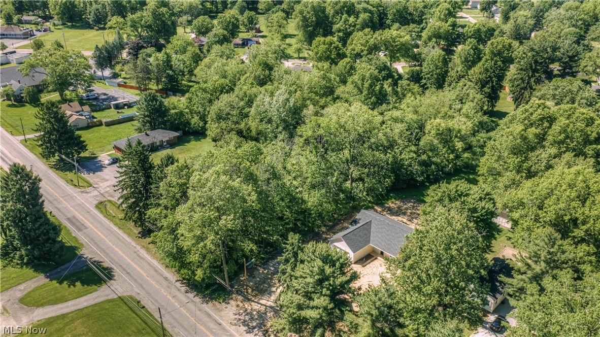 Exceptional vacant land opportunity in the heart of Tallmadge! If you've been waiting for the right opportunity to build a custom home in the highly regarded Tallmadge school district, you won't believe your good luck finding this beautiful wooded lot. At nearly an acre, this R4 zoned parcel offers a rare combination of privacy, mature wooded surroundings and city utility access, including public water, sewer, electric and gas that can be accessed.  Whether you’re looking to build a custom residence, take time thinking about development potential or simply secure land in a highly desireable area, this lot presents outstanding possibilities. If you favor a strong sense of community, Tallmadge offers so much including the Tallmadge Rec Center and Maca Park, a 65-acre park featuring the Maca Aquatic Center, picnic areas and ball fields nearby. You'll be located near shopping, restaurants and major commuter routes too, with a perfect mix of being in a natural setting. Take advantage of the potential that exists in this established and growing area of Summit County. You won't want this one to pass you by!