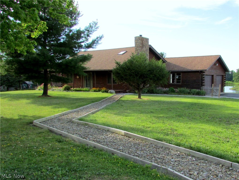 Escape to the tranquility of the country in this 3 bed 3 bath Log Home on almost 8 acres! A peaceful setting, gorgeous waterfront views, and park-like lot await you! Enjoy summer days where you prefer: there's a covered front porch, large back deck, 2-tiered patio with firepit, and even an island in the 2+ acre pond! The entire lot is fenced in & there's a barn with stalls, electric/water hookup, hayloft, and wood-working shop! Charm & character abound in this ranch style home with 16x16ft loft, vaulted ceilings, an open layout & updated kitchen & baths. Relax in the spacious living room & cozy up to the wood burning fireplace with Vermont Casting, stone surround, & rustic barn beam mantle. The kitchen includes all appliances, and a breakfast bar open to the dining room. A spiral staircase leads to the loft which overlooks the main floor with exposed beams & skylights for natural light. The Master Suite is complete with vaulted ceilings, plenty of closet space, and a large bathroom with jetted tub, tiled shower, & ceramic flooring. 1st floor laundry room has close accessibility to all 3 bedrooms. The full walk out basement is unfinished and awaiting your personal touches! It includes a full bath, workshop, framed in 4th bedroom, and a spot that's ready for a pellet stove with a stone hearth and ventwork. Everything has been well maintained or updated: water tank '14, windows '12, septic cleaned '12, well cleaned & new pump installed '11, water softener & pressure tank '05.