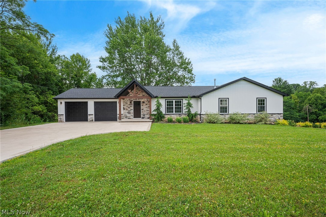 Rare opportunity to own a beautifully renovated Ranch, rebuilt from the studs in 2024, on a scenic 1-acre property in Concord within the Riverside School District. Offering 4 bedrooms, 3.5 baths & over 3,003 sq ft of finished living space, this home features a spacious walkout lower level, a low-maintenance composite deck & a covered stone patio designed for effortless indoor-outdoor living and entertaining. A covered front porch welcomes you inside to an open-concept layout anchored by a vaulted great room w/ dining space & an eat-in kitchen featuring stainless steel appliances, large center island w/ breakfast bar, walk-in pantry & access to the deck. A convenient 1st-floor laundry room adds everyday functionality. The vaulted primary suite is a private retreat w/ a dramatic floor-to-ceiling stone fireplace, direct deck access, walk-in closet & en-suite bath with double vanity & custom tiled walk-in shower. Two additional main-level bedrooms, feature a vaulted & tray ceilings. The finished walkout lower level is designed for entertaining and everyday flexibility, featuring a striking stone wet bar w/ a maple live-edge countertop, a 4th bedroom w/ walk-in closet, full bath & expansive living space that can accommodate a media room, game room, fitness area, home office, or additional recreation space. Sliding doors open to the covered stone patio w/ recessed lighting & a TV outlet, extending the living space outdoors. Additional highlights include a fenced dog run w/ low-maintenance ForeverLawn K9 grass & attached 2-car garage. RECENT UPDATES: Installed sidewalk & driveway pad, pavers & stone stairs, water filtration/softening system, fenced dog run area, gutter guards, custom window blinds, CAT 6 cabling (all 2025), upgraded faucets in kitchen & all bathrooms (2026). INCLUDED are ALL kitchen appliances and washer/dryer. Conveniently located near I-90, schools, parks, shopping, restaurants, and other local attractions. This home is a must see!