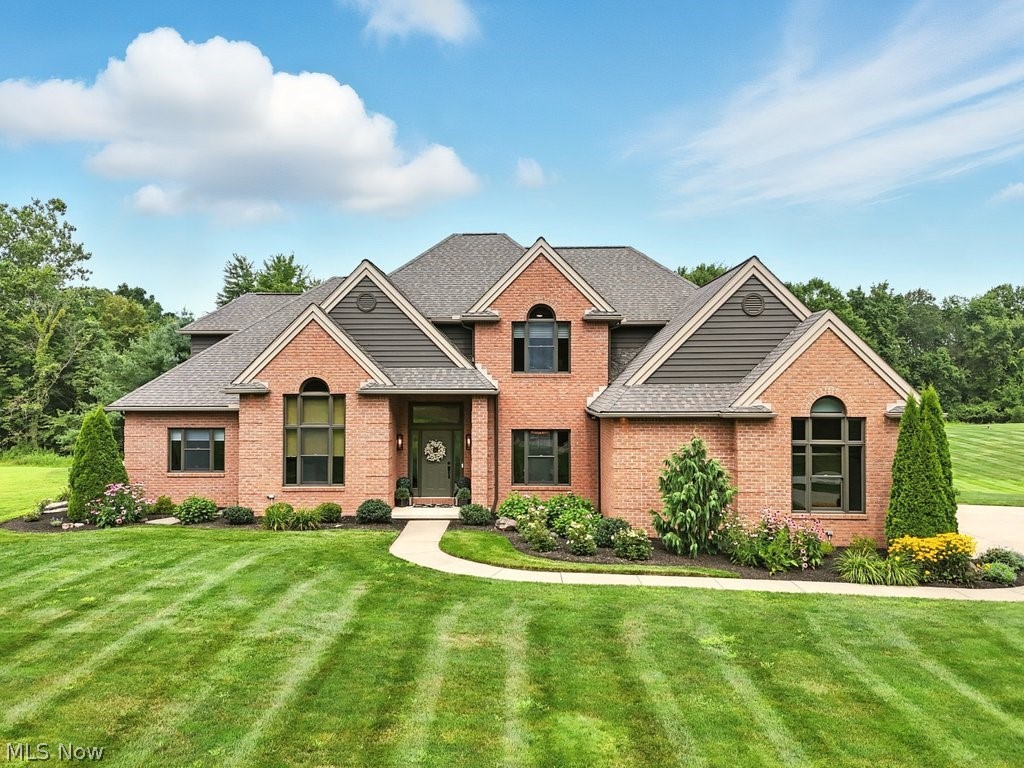 Stunning custom-built estate nestled behind a private gated entrance on 11.25 breathtaking wooded acres, where timeless elegance meets uncompromising luxury. Encompassing more than 5,500 square feet of meticulously designed living space, this extraordinary residence offers an unparalleled blend of privacy, sophistication, and exceptional craftsmanship just minutes from premier shopping, dining, and convenient access to Cleveland and Akron.

Designed for both refined entertaining and everyday living, the spectacular chef's kitchen showcases custom rustic alder cabinetry, dramatic quartzite surfaces, dual islands, a full-height quartzite backsplash, and premium built-in Café appliances.

The first-floor primary suite is a true private sanctuary featuring a spa-inspired bath with a freestanding soaking tub, dramatic double walk-in shower, custom cabinetry, marble flooring, and exquisite quartzite and marble finishes.

Upstairs, three generously sized bedroom suites offer beautifully appointed designer bathrooms, while the walkout lower level provides an exceptional lifestyle experience with a media lounge, recreation room featuring a wood-burning fireplace and bar, fitness studio, steam sauna, fifth bedroom or guest suite, and a full bath, perfect for extended family or overnight guests.

Step outside to your own resort-inspired retreat, where an in-ground pool and spa, expansive composite deck, elegant stone patio with gas fire feature, and peaceful wooded surroundings create an unforgettable setting for entertaining or quiet relaxation.

Offering the rare combination of exceptional design, luxurious finishes, complete privacy, and an ideal location, this remarkable estate represents a truly extraordinary opportunity for the most discerning buyer.