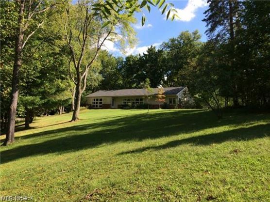 Looking for seclusion in Bath? Here it is! A winding driveway through the trees takes you to this sprawling hill top ranch home on over 2 acres where you will find fantastic veiws both to the front and rear of the home.  Absolutely fabulous interior. Totally renovated throughout. Large and open floor plan surrounds the gorgeous stone fireplace. Lots of windows and light. Rich hardwood floors, upscale cabinetry and granite counter tops. Spacious living room with a wall of windows overlooking the gorgeous lot. Huge great room opens to the kitchen and eating area. Nice master suite with cathedral ceiling and glamour bath. Full basement, 2 car garage, beautiful setting and so much more! Nearly an acre of open meadow is fenced and includes a one car detached garage perfect for lawn equipment. Home has a 2 car attached heated garage. Updates include: 50 year roof shingles done in 2009, hot water tank, furnace and C/A.  One of a kind!