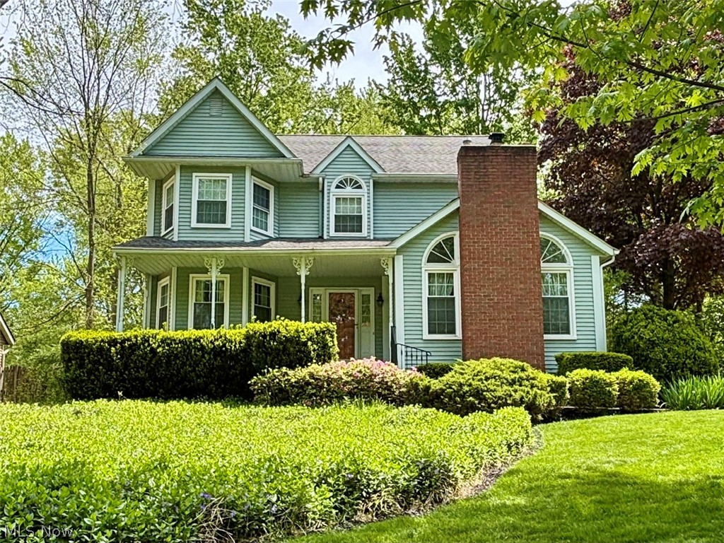 Proudly offered by the original owner, this well-maintained 3-bedroom, 2.5-bath two-story home blends classic curb appeal with thoughtful updates. A covered front porch with decorative columns and a prominent brick chimney welcome you, while arched windows, gabled rooflines, mature landscaping, and a stamped concrete walkway create a warm first impression.

Inside, the living room features a gas fireplace with a partially vaulted ceiling and abundant natural light. The main level offers wood flooring, a formal dining room with wainscoting, main-floor laundry (washer and dryer included), and a convenient half bath. The eat-in kitchen features quartz countertops, all appliances, and a sliding door leading to a large deck and concrete patio, creating ideal outdoor living and entertaining space.

Upstairs, the primary suite includes a walk-in closet and a remodeled en-suite bath (2016) with tile finishes, walk-in shower with bench, double vanity, and skylight. Two additional spacious bedrooms and a full bath complete the second level.

The attached garage offers usable attic storage. A whole-house generator (2022) adds peace of mind. Major updates include replacement windows and kitchen slider (approx. 2016), newer garage door and opener, water heater (approx. 2022), and whole-house generator (2022).