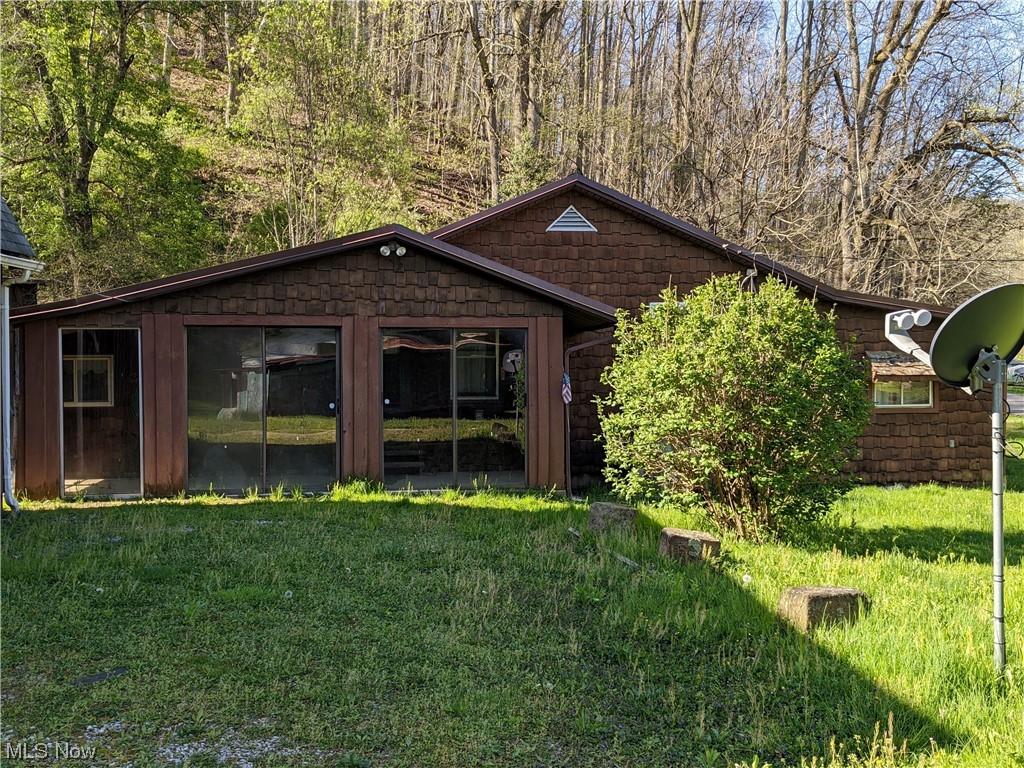 Welcome to this rustic dwelling in the country, yet conveniently located within 15 minutes to town for your shopping and medical needs.  An ideal property for someone starting out in life or retiring as you will love the simplicity that comes with this older nostalgic home as you relax on the sun porch and enjoy the serenity of nature around you. This home features 2 bedrooms, 1 bathroom, kitchen, living room and family room, the kitchen is small it could be expanded into the utility room if you need more space.  It also has large two car detached garage with a partially finished loft for an extra bedroom if needed. There are outbuildings featuring a woodworking shop, cellar house with storage above, also a metal shed for mowers all conveniently located on the 4.18 acre property. There is also a mobile home on the property in very poor condition if removed it would be an ideal location for camper or a tiny home. Schedule a personal tour to see this home and all that it has offer!