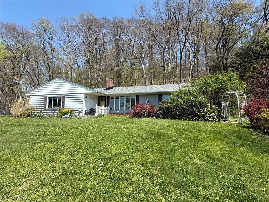 Well maintained 2 bedroom, 2 bath cedar ranch.  Open floor plan with hardwood floors and gas fireplace in the living room.  Beautifully updated kitchen with solid surface counters features an island breakfast bar with granite counters.  Updated main floor bathroom with quartz counters.  Spacious sun room provides panoramic peaceful country views.  Finished rec room in the lower level features knotty pine tongue and groove accent wall and wood burner.  Rear patio with built in wood grill.  2 car attached garage.  80 gallon hot water heater is a rental-$22 per month.  Updates throughout include RO system is new in 2017, updated electric in 2021, roof new in 2024, boiler new in 2026.  16 X 18 detached garage with new overhead door and attached storage area.   Peaceful 2.17+/- acre wooded country setting providing fantastic scenic views.  A must see!  Seller is reserving mineral rights.