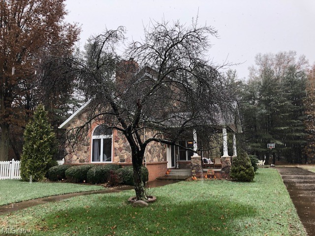 Immaculate and beautiful describes this unique 3 bedroom, 2 1/2 bath stone and vinyl  home at the edge of town.  An inviting 2 story foyer leads to the sunken living room with a cathedral ceiling and includes a brick double sided fireplace that opens to the office.  The office opens to a beautiful 15 x 13 covered patio with lots of privacy and is perfect for entertaining.  This impressive open kitchen includes a huge center island with a granite counter top, solid wood cabinets, and tile flooring.  Appliances are included.  The kitchen opens to the family room that includes a breakfast counter and also leads to the private fenced in side yard.  The 22 x 13 Library includes trayed ceiling and built in cabinets.  The large master suite boasts 10.5' ceilings, and an additional separate sitting area that also includes a cozy fireplace.  Stunning master bath with a soaking tub, separate shower, his and her sinks, and a huge walk in closet.  Convenient first floor laundry.  The 2 car attache