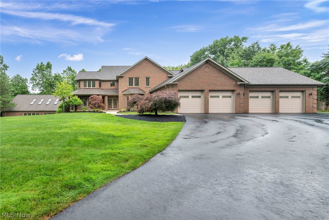 Nestled on just under 5 private wooded acres, this stunning custom-built brick estate offers 6,492 square feet of exceptional living space, a heated 4-car garage with mop basin and hot and cold water , and unparalleled craftsmanship throughout. Lovingly maintained by its original owner, the home is accessed by a picturesque driveway that winds through mature trees, creating a peaceful and serene setting surrounded by nature.

Featuring 4 bedrooms, 6.5 bathrooms, and a flexible 5th bedroom or office option, sewing room or another office, this remarkable residence combines luxury, comfort, and functionality. The spectacular custom kitchen is the heart of the home, boasting abundant cabinetry, a large center island, and an open design that overlooks the expansive great room with a beautiful fireplace.

The private primary suite serves as a true retreat, complete with custom-designed closets and luxurious accommodations. Every closet throughout the home has been thoughtfully customized, while the exquisite woodwork showcases the superior quality and attention to detail found in every room. Additional spaces include a spacious laundry room with endless versatility and a separate office or sewing room.

The walkout lower level is an entertainer’s dream, featuring a large recreation area with a second fireplace, an additional bedroom and full bath, and a dedicated workout room. One of the home's most extraordinary features is the attached indoor pool & Jacuzzi area, complete with its own fireplace, creating a year-round resort-style experience.

From the breathtaking setting to the unmatched craftsmanship, this one-of-a-kind estate offers a rare opportunity to own a truly exceptional home.
2 New Boilers, new Furnace and AC unit three years ago, New roof two years ago, irrigation system, 6 zone R Zel system throughout home, 600 Amps in basement, Hydronic heating in all concrete flooring - basement, pool room & garage