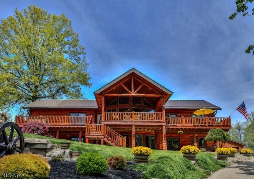 Welcome to your own private paradise on sought-after Beech Street in the Louisville School District! Nestled on 10 breathtaking acres, this stunning log veneer home blends rustic elegance, luxury, and endless opportunity. An already designated 5-acre split offers the potential to build another spectacular home, private guest retreat, or investment property.  Fully furnished and designed with the warmth and charm of a mountain lodge, this turnkey property allows you to move right in and begin living the dream. With its serene, resort-like setting, every day feels like a vacation. Outdoor living is simply extraordinary. The impressive 18x40 saltwater pool serves as the centerpiece of this entertainer’s paradise, featuring a whirlpool cascade hot tub flowing into the pool, a poolside fireplace, and covered patio spaces perfect for relaxing or hosting unforgettable gatherings. Massive stone retaining walls, sprawling front decks, covered patios, and private wooded surroundings create a breathtaking atmosphere.  Inside, the home offers 3 spacious bedrooms, including an elegant owner’s suite designed for comfort and luxury. The primary retreat features two incredible walk-in closets that are sure to impress, combining sophistication with exceptional functionality.  Car enthusiasts and hobbyists will love the incredible outbuilding with space for 3 vehicles, including a lift, plus a 2-car detached garage and an additional 2-car attached garage. Beneath the 3-car garage is an even more amazing storage space. Steel roofing throughout, cement and asphalt driveways, and quality craftsmanship complete this one-of-a-kind estate.  Private yet conveniently located, this remarkable property offers luxury, recreation, seclusion, and limitless possibilities in one unforgettable setting. A rare turnkey opportunity you do not want to miss!