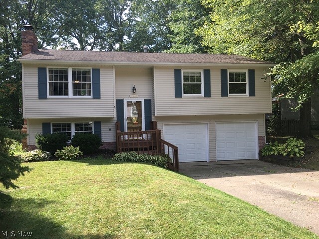 Very well maintained raised ranch in desirable area of Munroe Falls close to shopping, schools, restaurants, parks and library.  This seller has lovingly cared for their home but have outgrown it.  Home has been freshly painted inside and  power washed and painted deck and front porch.  There are new garage doors and openers. In 2017 there was a new furnace and air conditioning.  Their children love the back yard.  It is totally fenced in and lots of room for pool, swing sets and more.