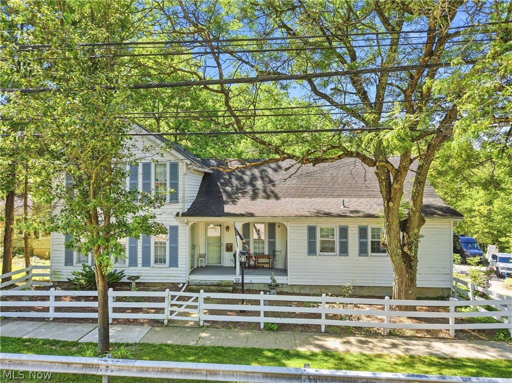 Rare opportunity in the heart of Chagrin Falls Village! Situated on an exceptional 1.1-acre lot and located directly on the beloved Memorial Day Parade route, this 4-bedroom, 2.5-bath home offers a combination of features seldom found within the Village limits. Perfectly positioned between Chagrin Falls Intermediate School and Chagrin Falls High School, the location provides exceptional convenience while remaining close to all the charm of Village living.

The home boasts a coveted first-floor owner’s suite complete with a spacious walk-in closet, providing convenient one-floor living. Hardwood floors extend throughout both the main and upper levels, adding warmth and timeless character throughout the home.

Additional standout features include an attached garage and a walk-out lower level—amenities rarely available in Village properties. The expansive 1.1-acre setting offers unparalleled privacy and outdoor space while still being just moments from the shops, restaurants, parks, and restaurants of downtown Chagrin Falls.