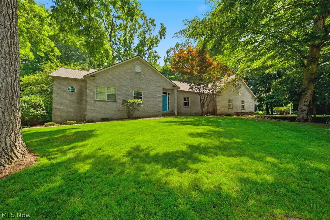 OPEN HOUSES THURS 5-7, FRI 2-4, & SAT 10-12- This is the one! Tucked away on an acre on a dead end street, this custom built Plain Township brick ranch offers over 2,600 square feet of living space! The kitchen is an entertainer's dream, offering copious counter and cabinet space, plus a large island with an additional prep sink. Off the kitchen, you will find an extra large dining area that leads to the incredible sunroom which walks out to the deck and overlooks your private backyard oasis! The entertaining doesn't stop in the kitchen- The great room boasts vaulted ceilings, skylights allowing for even more natural light, AND a wet bar! Around the corner, the primary bedroom connects to a HUGE walk-in closet and ensuite bathroom, complete with a separate area to get ready, a jetted bathtub, walk-in shower, and so much storage! The second spacious bedroom has a large closet and is located across the hall from another full bathroom with extra linen storage. Down the hall, the third bedroom conveniently connects to the semi-private half bath and leads to the large first floor laundry room with extra counter space with a sink. The attached, extra deep garage leads to a third garage bay with an extra tall garage door, floor drain, workshop area, and utility sink. The full unfinished basement has walk-out access, is plumbed for another bathroom, and has potential for even more living space! Major updates include Roof, Gutters, Downspouts, & new Skylights (2025), Well pressure tank (2021), Well pump (2018),  A/C (2020), and Furnace (2017). Don't miss your opportunity to view this incredible home!