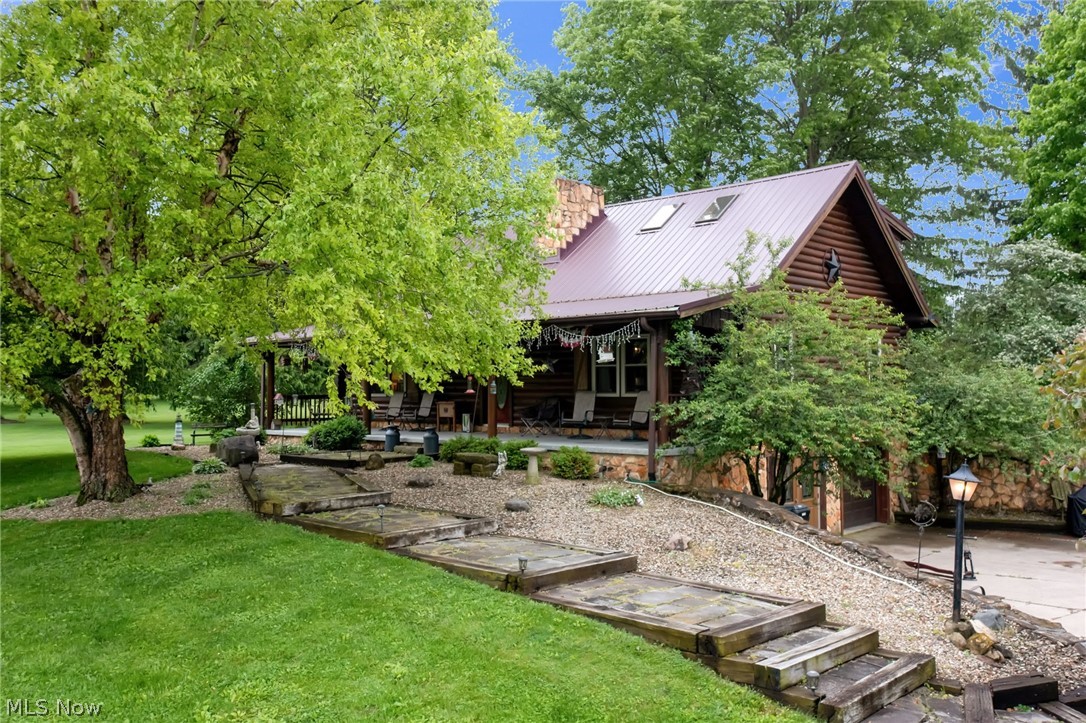 Escape to the charm and privacy of country living in this well cared for cabin retreat nestled on 3.33 acres. If you have been searching for a home with acreage, a large garage, and flexible living space, this property offers a rare combination of character and functionality. The main floor features a bedroom, full bathroom, and convenient mudroom for easy everyday living. The spacious living room showcases vaulted ceilings with an open loft above, creating the warm and inviting feel buyers love. Upstairs offers two additional bedrooms and a second full bathroom. The walkout basement expands the possibilities with kitchenette hookups, abundant storage, and additional flex space for a home office, guest suite, recreation area, or possible fourth bedroom with attached half bath. Outside, the detached 32x40 garage provides room for 3+ vehicles, hobbies, equipment, toys, or workshop space, plus an additional yard shed for storage.