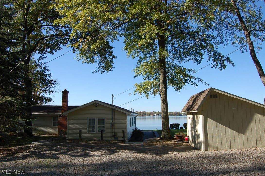 One of the best views on Lake Milton! Perfect summer cottage in ready-to-use condition. Beautiful views from sun porch, kitchen, and covered deck every day! Perfect for the avid boater with a boat dock and sea doo docks, and sun deck. Many updates include roof shingles, kitchen, HVAC, paver walks, and patio.