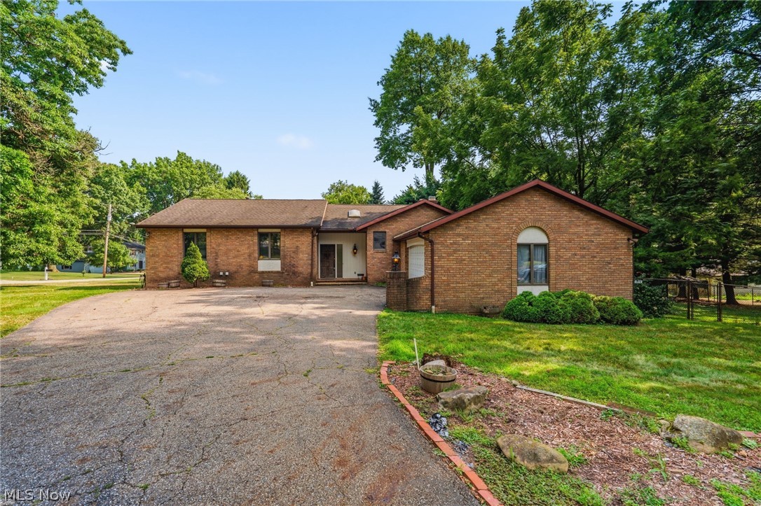 Welcome home to this thoughtfully designed ranch offering timeless architecture, abundant natural light, and an exceptional floor plan in one of North Canton's most desirable locations.  From the moment you step through the grand entry, you'll appreciate the home's soaring vaulted ceilings with striking wood beams, expansive windows, and an inviting great room centered around a cozy gas fireplace with a raised hearth. The layout offers spacious living and entertaining areas, while the finished walkout lower level provides incredible flexibility with a large recreation room, full bar, ample storage, and a potential 4th bedroom with walk-in closet and walk-out access.  The primary bedroom is expansive with walk-in closet and attached primary full bathroom, with double vanity, soaking tub, and lovely architecture. Outside, enjoy a fully fenced backyard offering both privacy and space to relax and entertain, complete with storage shed and situated on a corner lot that ends in a cul-de-sac. A two-car garage and abundant storage throughout add to the home's everyday convenience.  Combining character, functionality, and an unbeatable location close to shopping, dining, parks, and everyday amenities, this is a home you'll be proud to call your own! Roof: 2001 Furnace, A/C, and thermostat: 2020 Samsung Refrigerator: 2023 Dryer: 2018 Maytag Washer: 2025 Hot Water Tank: 2016, Property is being sold AS-IS.