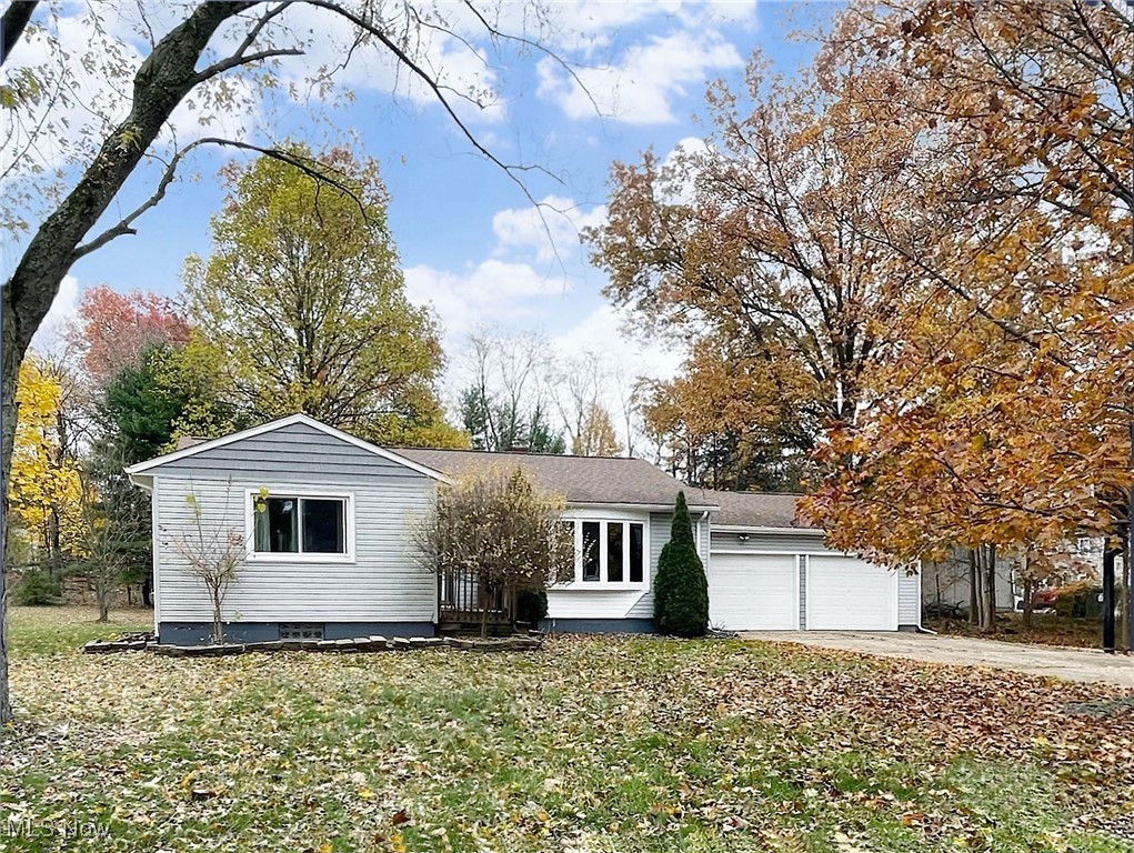 If you’ve been looking for a country setting without the drive, this 3-4 bedroom ranch in Stow will be perfect, with solutions to many things you’ve been holding out for. Located on two parcels totaling a half-acre, the home boasts a fantastic floor plan that will provide comfort and ample space for all of your needs, both inside and outside. On entry, you’ll walk into a comfortable living room featuring a pretty bow window. The kitchen was updated in 2020 with stainless-steel appliances, that stay. Turn the corner and you’ll be in the heartbeat of the home: a lovely open dining room with bay window, overlooking a family room with woodburning fireplace and exposed beamed ceiling, both which feature beautiful cherry wood floors. Have a need for multi-generational living or a teen that wants his or her own space? The lower level has a fantastic rec room, plus a 12x10 finished room that can be set up as a bedroom or it can easily double as a home office. There’s a full bath on this level and laundry is nearby. Bring a work vehicle home? You'll appreciate all of the parking possibilities the property has to offer. The main driveway is long, and even has a driveway extender to accommodate more vehicles. The side parcel driveway goes back over 180 ft., leading to an additional 2-car detached garage with gravel drive. In the last 5 years the home has had a new roof, kitchen, HVAC, siding, 15 new windows, flooring in the dining and family rooms, and the addition of the 2-car detached garage. You’ll love the location, too. The Stow Library, shopping and restaurants aren't far away, and if you value community, Stow offers a total of 10 parks – including 6 neighborhood parks and 4 community parks offering amenities like playgrounds, tennis courts, access to hike and bike trails, and KSU is about 15 minutes away. Add in the top ranked school system with its many resources, and strong curriculum that values student success, and this one is a sure winner!