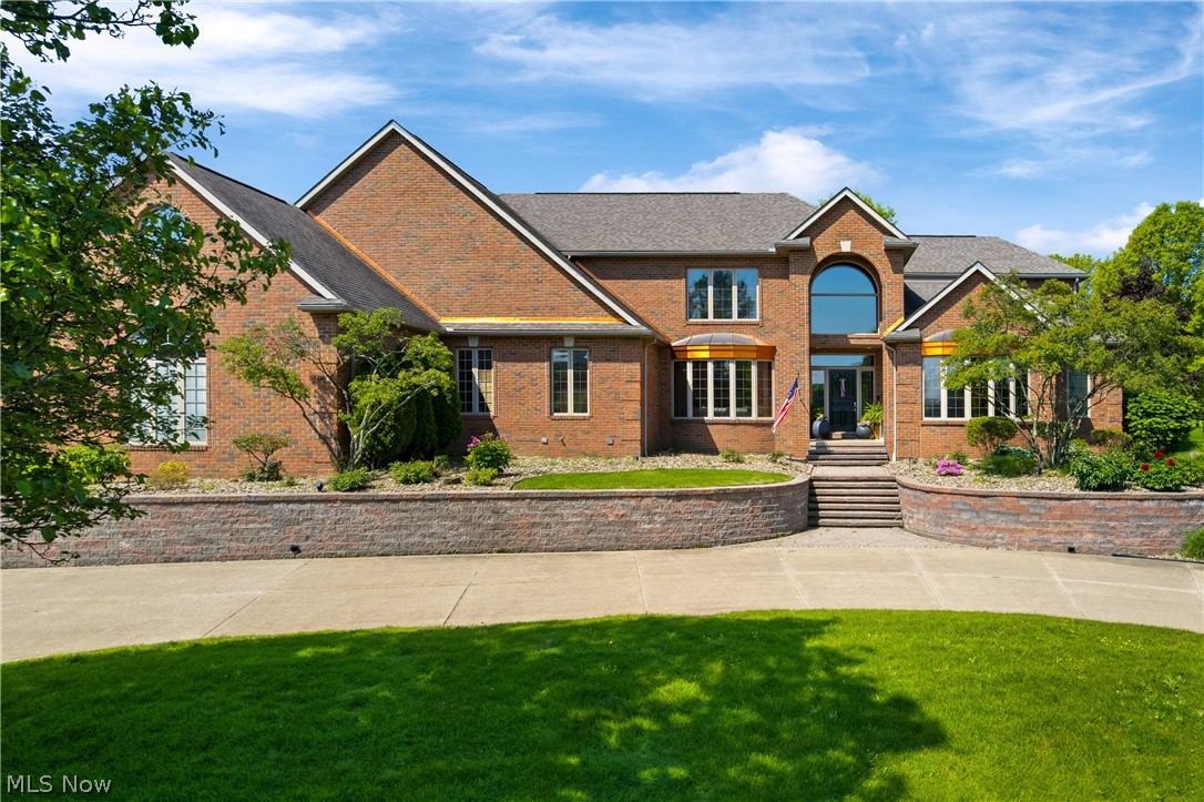 Welcome to this all-brick estate, situated just off the 2nd green of Glenmoor CC Golf Course. The area’s most prestigious gated community. Offering a seamless blend of timeless elegance and modern updates, this home is designed for both everyday living and effortless entertaining. The fully remodeled main level showcases rich hardwood floors and a flowing layout filled with natural light. A private first-floor office with vaulted, beamed ceilings creates an ideal work-from-home space. The impressive two-story great room features a stone gas fireplace and expansive windows capturing beautiful golf course views. A four-seasons sunroom provides a bright, relaxing retreat, while a cozy den off the kitchen adds flexibility. The completely remodeled kitchen is the heart of the home, complete with custom Amish cabinetry, Café appliances, an induction cooktop, and a custom beverage bar. The first-floor owner’s suite offers a private escape with dual vanities, two walk-in closets, and a spa-like bath. Upstairs, a junior suite, two additional bedrooms, and a spacious bonus room provide versatile living options. The finished lower level expands the home’s functionality with a full bar, recreation area, fitness space, fireplace, abundant storage, and direct garage access. Outdoor living is elevated with a custom kitchen and built-in commercial-grade gas grill, perfect for entertaining while enjoying sweeping fairway views. Schedule a private tour of this one-of-a-kind property to experience all it has to offer.