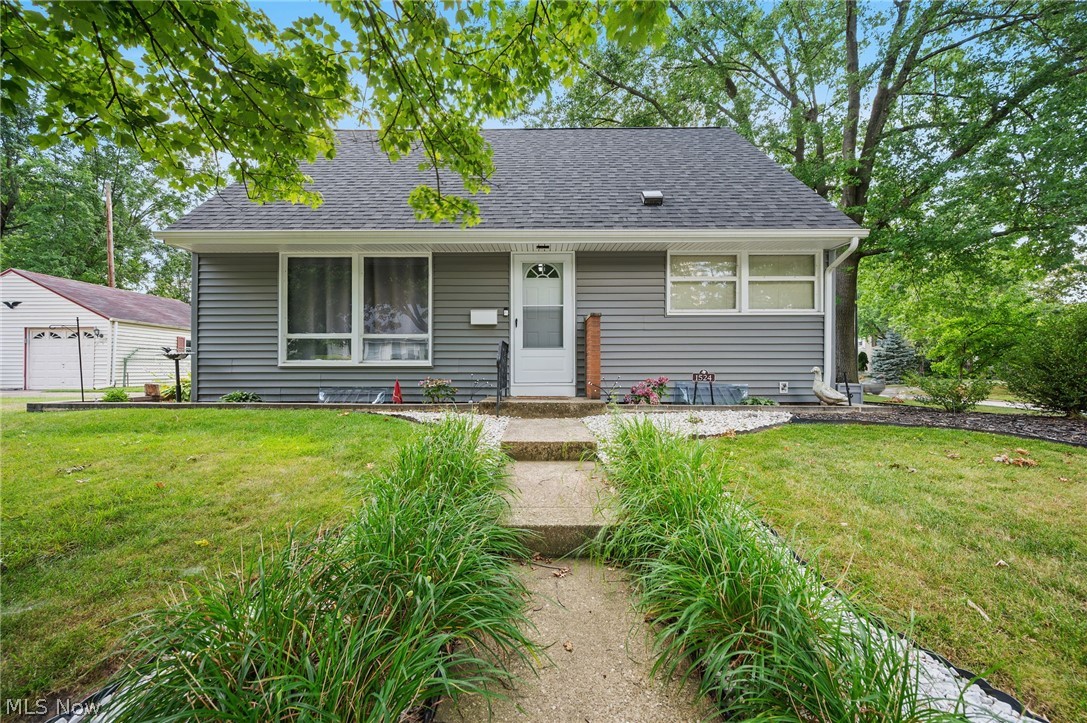 Welcome home to this charming Cape Cod that's full of character, space, and flexibility! Beautiful hardwood floors flow throughout much of the main level, featuring a first floor bedroom, spacious living room, and a generous dining area with sliding doors leading to the covered back patio—perfect for entertaining or simply relaxing while overlooking the fully fenced backyard. The galley style kitchen offers abundant cabinet and counter space, stainless steel appliances, recessed lighting, and a functional layout for everyday living. A convenient first-floor bath completes the main level. Upstairs, you'll find two spacious bedrooms, along with a full bath. The upstairs provides the perfect flex space for a home office, playroom, hobby room, or guest area. The lower level offers even more versatility with a large recreation area, multiple bonus rooms, laundry space, workshop area, and plenty of storage. Outside, enjoy the covered back patio, fully fenced backyard, and oversized detached two car garage with plenty of room for parking, storage, or projects. Conveniently located near parks, shopping, restaurants, schools, and major highways, this home offers the perfect blend of comfort, functionality, and everyday convenience. Schedule your private showing today!