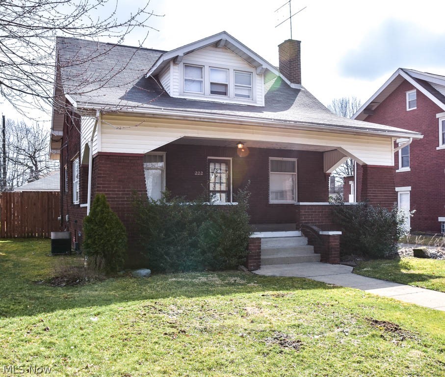 Tons of potential in this all-brick 2 bedroom colonial with a fenced-in backyard in Harter Heights! Great curb appeal with a 27x9 covered front porch. Step into the massive living room with a brick fireplace. French doors lead to the sun-filled dining room with hardwood flooring and walls of windows. The kitchen comes fully applianced! It has a deep pantry and a breakfast nook. Upstairs, the master bedroom offers a tandem dressing room with 2 closets. There’s an additional bedroom with a walk-in closet. The full bath is roomy and has built-in storage. More storage in the full basement! 2-car detached garage, too. Relax outside in your super private, fully fenced yard with a patio. Situated on a charming brick road. This home is Sold As-Is. Schedule a private showing today!