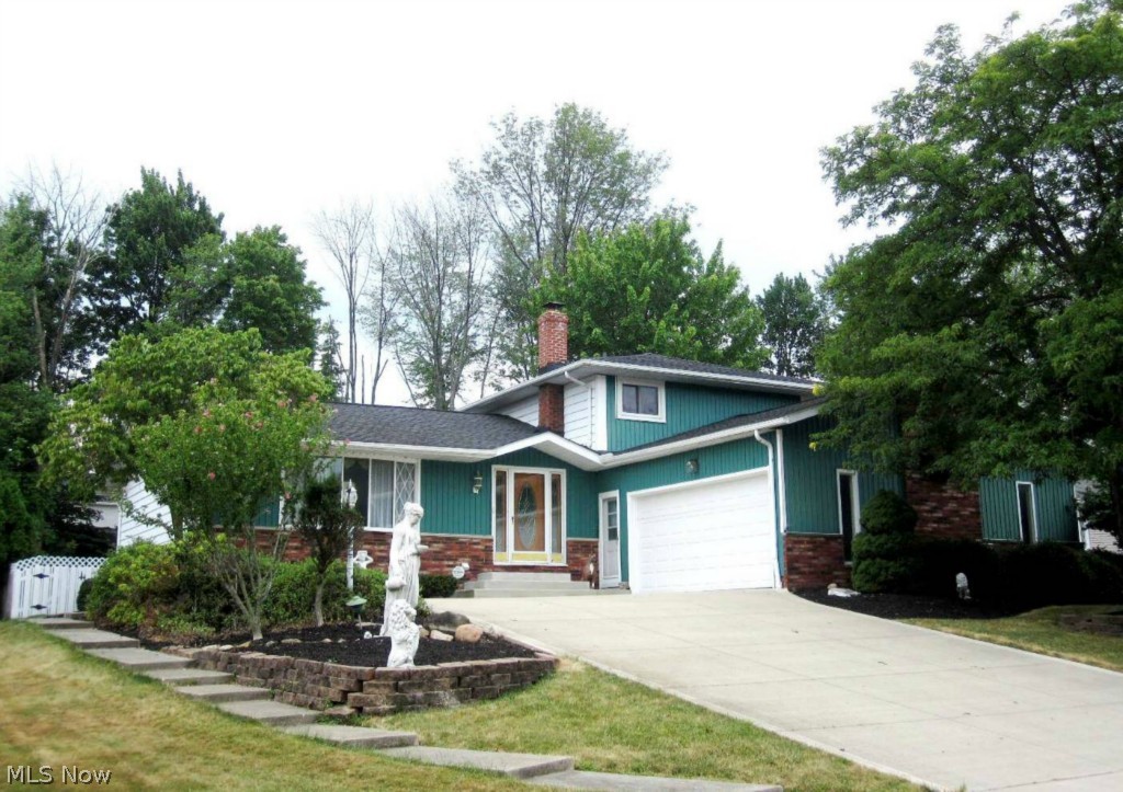 Spacious 4-level split with 54X21 addition boasting a built-in pool, kitchen, full bath and recreation area.  A tiled foyer opens to the formal, vaulted living room and dining room, which is adjacent to the large eat-in kitchen.  From the kitchen, step down to the lower level featuring the family room with wood-burning fireplace, the 4th bedroom, a half bath and the laundry room off the 2 car, heated garage.  There are 3 bedrooms upstairs including the master with a walk-in closet and private bath.  The basement offers an additional recreation area, storage and utility rooms.  Updates include newer carpet in the lower level family room, some windows, roof and concrete.  This unique home with its own "rec center" has been well cared for and just needs your personal touch.