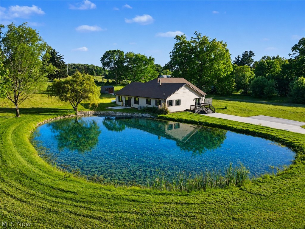 Experience the perfect balance of peaceful country living and contemporary updates in this beautifully renovated RANCH HOME situated on 2.78 scenic acres. Offering four bedrooms and 2.5 baths, this exceptional property provides the space, privacy, and amenities today's buyers desire.

At the center of the home, the stunning kitchen is designed to impress, featuring a massive 13-foot granite island, abundant workspace, and stainless steel appliances—ideal for entertaining, gathering with family, or everyday living. Large new windows fill the home with natural light, while a new sliding glass door opens to the outdoor living area and picturesque pond views.

Outside, you'll find your own private retreat complete with a tranquil pond accented by an illuminated sprinkler, creating a beautiful focal point day and night. Recent improvements include a newly paved driveway, a roof approximately three years old, and a new furnace installed in 2023, providing peace of mind for years to come.

Adding to the property's unique appeal, you're just a short walk from the area's favorite destination, White House Fruit Farm, making fresh blueberry donuts and seasonal outings part of your everyday lifestyle.

Whether you're enjoying quiet evenings by the pond, entertaining guests in the expansive kitchen, or simply taking in the beauty of your acreage, this remarkable property offers a lifestyle that's hard to find and impossible to forget. Welcome home.