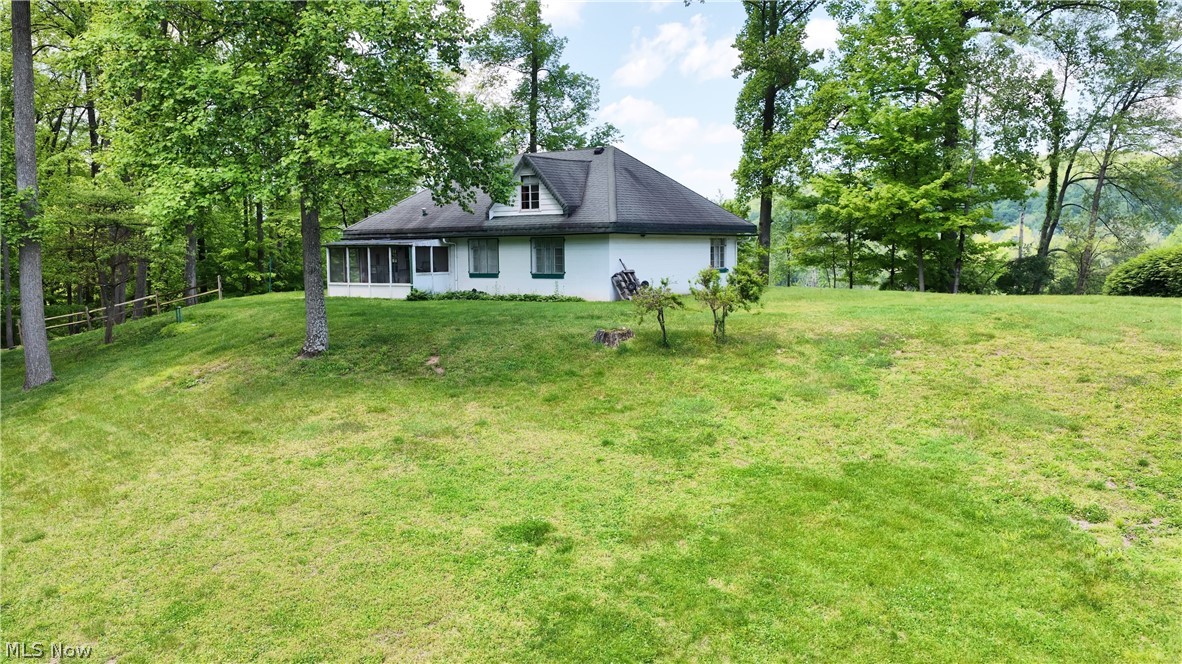 Here’s 28+ acres of wooded recreational land with a cement block home and a detached garage selling as one unit. Whether you want to use it as a permanent residence or your recreational hide-a-way it deserves your attention. The one and a half story home
with some major remodeling can be a comfortable small home or with some cosmetic updating can be your get-a-way spot. There are 2 small bedrooms on the first floor and one on the second floor plus additional storage/ attic. The first floor also has the kitchen with dining area, living room, and bathroom. Enclosed back porch, giving it a greenhouse vibe.  The house is built on a slab. Heat is provided by a fuel oil furnace and the water supply is a spring w/pressure tank. The land is mostly hillside, has some mature trees, some outcrop rocks, and is loaded with wildlife.  Prime location, minutes from Millersburg but far enough in the woods offering it a seclusion feel.