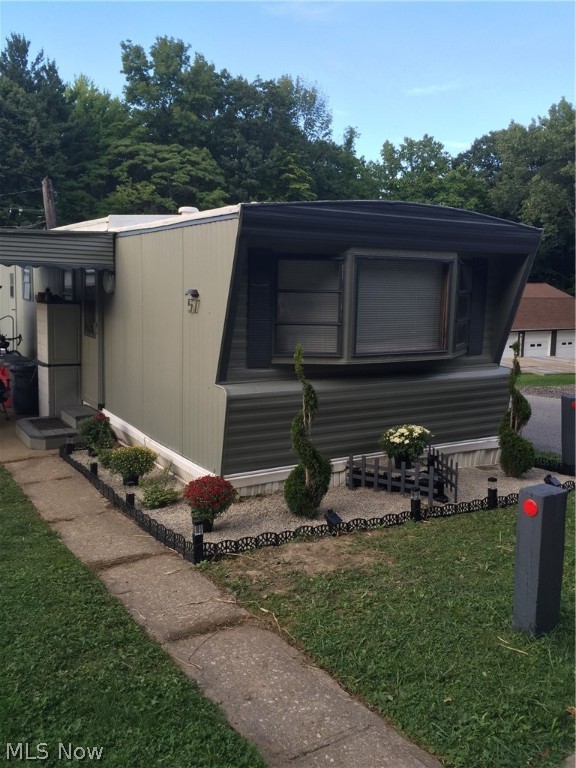 Kirtland Mobile home park offers this affordable living unit. 2 bedrooms with updated kitchen is open to the large living room. Nice sized master bedroom with a smaller second bedroom. Large bath, laundry room with washer and dryer included. Low maintenance, recently painted. Nice home  that sits at the end of the street with a vacant lot next door makes this a nice more private unit.