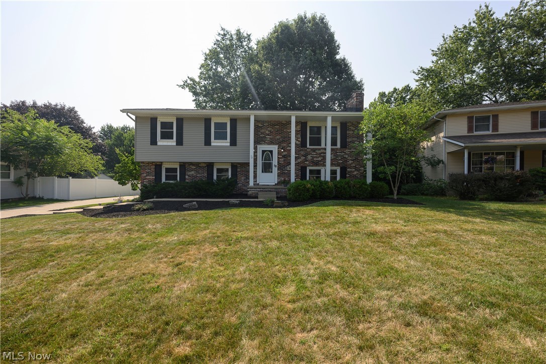 Welcome to this updated home, ideally situated within the Perry Local School District. This property boasts a host of desirable features, including a rear-facing two-car garage with ample parking and a paved driveway. There is a spacious shed on a concrete slab and a fenced backyard with scenic views that enhance the exterior. You'll also find a new roof with guarded gutters and new downspouts. Inside, you'll discover new flooring throughout. The kitchen is a highlight, featuring new soft-close cabinetry, quartz countertops, and stainless steel appliances. The upstairs living room has plenty of natural light and is adjacent to the dining area. The bathroom offers a tiled shower surround, a new toilet, and a granite countertop. All bedrooms come with new carpet, paint, and new doors. The lower level provides additional living space with a full bathroom, a complete laundry setup, and a large recreation area featuring a wood-burning fireplace. The double doors lead to a rear patio, perfect for outdoor enjoyment. Schedule your showing today!