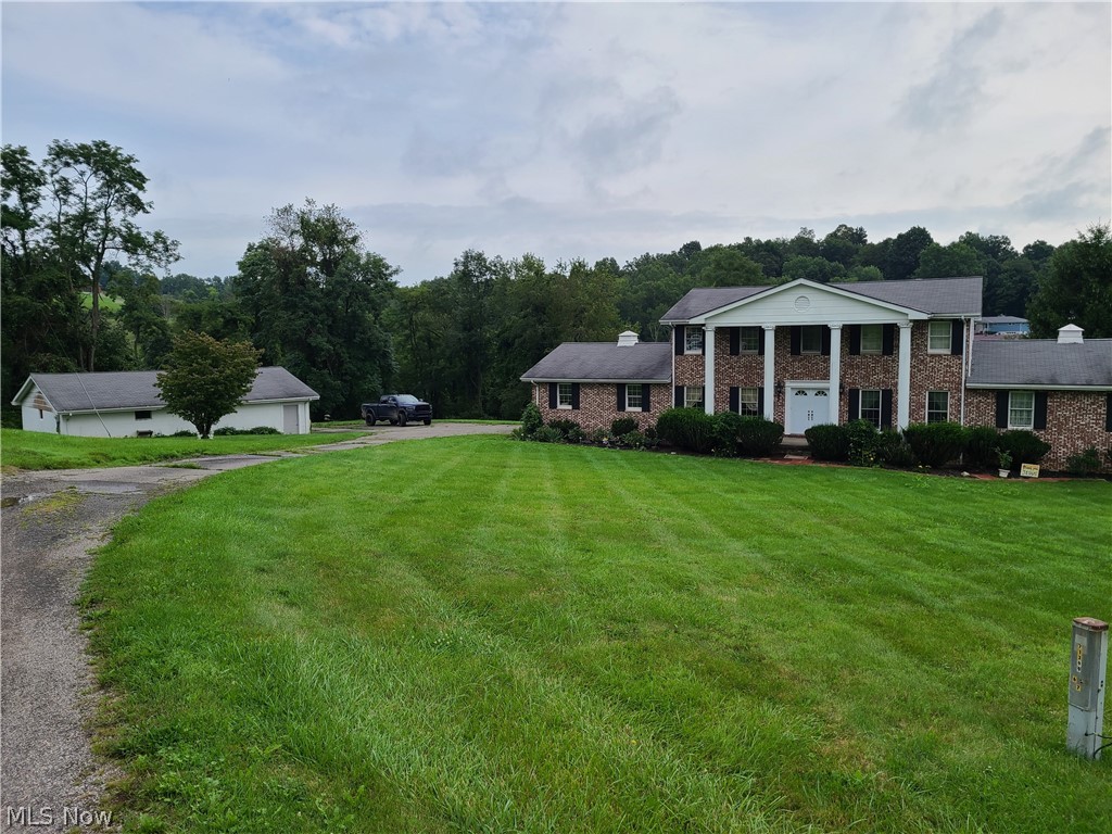 Bring your imagination to this sprawling property.  Large family home on over 11 acres in a great neighborhood.  The main home includes 4 large bedrooms and 2.5 bathrooms.  There is a large family room and a large rec room on the main level.  Attached 2 car garage and a 4 car detached garage.  The property also has an additional small home that has been partially converted into a cooking area for a catering service.  The appliances used in the small home will not be included in the sale.  The property is being sold as is with some updates needed.  This property will make a great family home with plenty of room to roam and enough garage space for the recreational vehicles or start a mini farm.  The owner will be holding an auction the beginning of September for the personal items in all the structures.  These types of properties don't come to the market often.  Schedule a showing soon!