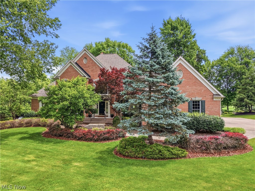 Set within Barrington's gated golf community, this distinguished Ken Payne built, all-brick Transitional home commands breathtaking views of the fifth fairway. Framed by meticulously curated landscaping and timeless architecture, the residence seamlessly blends classic touches with thoughtful updates. A dramatic two-story great room serves as the heart of the home, where soaring ceilings, a stately fireplace, custom built-ins, a wet bar, and walls of windows create an unforgettable setting flooded with natural light and panoramic golf course vistas. Formal living and dining rooms offer refined spaces for entertaining, while a richly appointed library provides a private retreat for work. The recently refreshed chef's kitchen has been thoughtfully reimagined with new quartz countertops, sink and faucet, refinished custom Amish cabinetry with soft-close drawers, new appliances including a gas cooktop and refrigerator, and elegant under-cabinet lighting that highlights every detail. The main-level primary suite offers a private sanctuary, featuring vaulted ceilings, dual walk-in closets, and a spa-inspired bath with an upgraded shower. Upstairs, three generously proportioned bedrooms and two full baths are accessed by dual staircases, enhancing both flow and functionality. The finished lower level extends the home's living and entertaining possibilities with a spacious family room, full bath, and convenient garage access. Throughout the residence, fresh designer paint palettes, new carpeting, and extensive LED lighting create a bright, contemporary aesthetic. Significant mechanical investments—including high-efficiency furnaces, water heaters, and a new air-conditioning system—provide exceptional comfort and peace of mind for years to come. A maintenance-free deck invites effortless outdoor living, overlooking the lush fairways and water views that define this remarkable setting. Impeccably maintained and thoughtfully updated, this is country club living at its best.