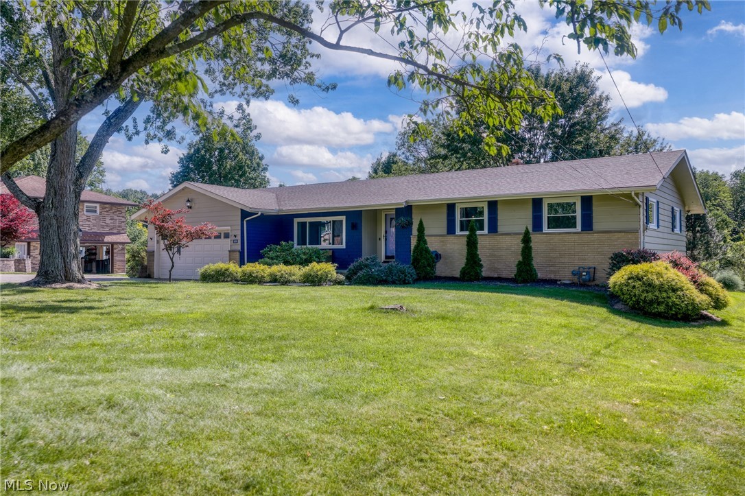 You'll enjoy the relaxing setting of this beautifully renovated, landscaped, and spacious 4 bedroom ranch, with an expanded vaulted great room bringing the home to over 2,000 square feet of living space. Great curb appeal welcomes you home, with a large front yard shaded by tall trees and a wood, shake, and brick exterior finished with a covered front porch. Gleaming refinished hardwood floors and a light, bright feel greet you as you step into the foyer and take in the large living room and dining room. They also offer fantastic views of the rear lot. This home has just undergone a full remodel of the kitchen and both bathrooms, along with new windows throughout, giving it a fresh, move-in ready feel. The eat-in kitchen is a true showpiece with beautiful wood cabinetry extending to the ceiling, quartz counters, tile backsplash, center island, and a stylish full suite of black appliances. The island is the perfect vantage point overlooking both the kitchen and the great room, which impresses with its vaulted ceiling, French doors to the deck, and windows on all sides framing views of the surrounding yard. A newly remodeled powder room sits just off the kitchen, featuring a shiplap accent wall. Down the hall, four nicely sized bedrooms are serviced by a full bathroom that has also been beautifully remodeled, complete with a shiplap wall, double vanity, granite countertop and tile flooring. The lower level offers plenty of storage, a workshop area, shower, laundry area, and more, ready for your finishing touches. Outside, enjoy a private wooded yard with tall pines and a wraparound deck, perfect for entertaining. The larger driveway provides plenty of parking, and the home includes a shed with electric and Arzel zoned heating for added comfort. All of this in a great location within award winning Brecksville Schools, with easy access to the newer elementary school, shopping, Metroparks, and the state of the art Broadview Heights Rec Center, plus easy highway access.