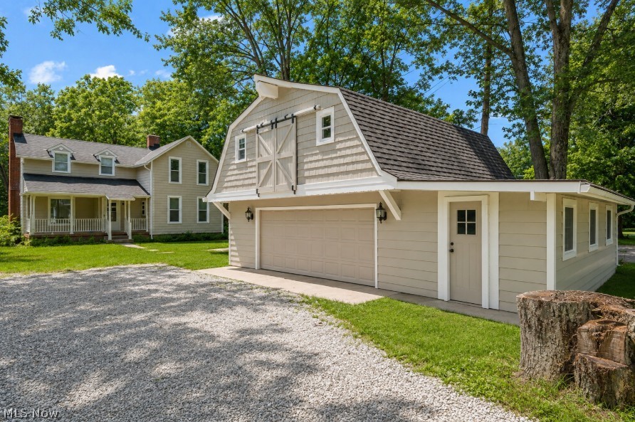 Welcome to this fully restored 4 bedroom, 2 bathroom Colonial on nearly half an acre that backs up to the Cleveland Metroparks with trails just a short walking distance away! There is a large 800+ square foot 2 car garage as well with plenty of storage and a large area above that could be finished out for additional living space. The siding has been fully painted along with brand new windows throughout the house and the garage! As you walk in you will notice the beautiful hardwood flooring throughout with a large, welcoming living room. The kitchen has been fully remodeled with tile flooring, new cabinets, quartz countertops, stainless steel appliances and lighting. The main floor features a large living room, the kitchen, a full bathroom, breakfast area, dedicated dining room and a sun room with plenty of light coming through with views of the woods. Upstairs has another full bathroom and the 4 well sized bedrooms. Both bathrooms have brand new vanities, fixtures, tile and more. As you go downstairs you will walk into the rec room. Behind is the separated laundry area and utility room with a new hot water tank, updated electrical box, wiring and more. Come check out 889 Grayton road today in Berea!