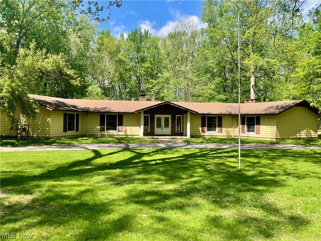 Welcome to this sprawling ~3,000 sq. ft. ranch in the highly desirable Kirtland Hills Village, set on over 5 acres of peaceful, scenic land. This serene property truly has it all! Step inside to a stunning living room featuring a cozy wood-burning fireplace, a wall of windows that fills the space with natural light, and sliding doors that open to the back patio and picturesque pond. The updated kitchen boasts abundant cabinetry, granite countertops, and stainless steel appliances, and flows seamlessly into the dining area complete with its own wood-burning fireplace and patio access, perfect for indoor-outdoor entertaining. With its expansive layout, the home also offers a large family room ideal for gatherings or easily converted into a game room, complete with another set of sliding doors to the outdoors. The spacious primary suite is a true retreat, featuring dual closets, private patio access, and a beautifully updated en-suite bath with a tiled shower. Three additional generously sized bedrooms, along with a guest bath, laundry room and a convenient powder room, complete the interior. Car enthusiasts will appreciate the impressive 4-car garage. Outside, enjoy a large patio designed for entertaining, all overlooking a tranquil pond that enhances the natural beauty of the property. Home comes with a whole house generator! Some updates include: Natural gas conversion 2020, Furnace w/UV disinfection and Humidifier system 2020, A/C unit 2020, Water tank 2020, water softener 2020, whole house generator + 200AMP upgrade 2021, Septic 2023, Pond aeration 2022, and Reverse osmosis system 2020. All this and the home comes with a 1-year warranty! Call today for you private showing as this one won’t last long! Added benefit Kirtland Hills has no city tax!!