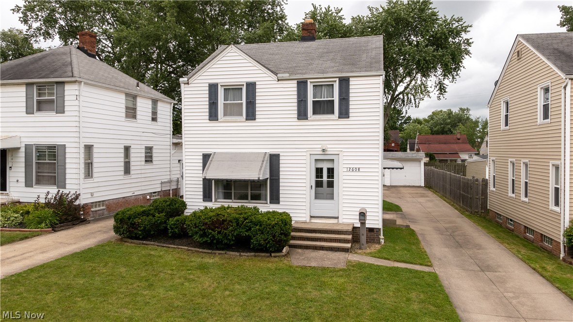 12608 Thraves Ave Garfield Heights is a beautiful Colonial home that will meet all your needs. This 3 Bedroom 1 & a 1/2 bath home has wood grain floors throughout the 1st &2nd floor installed 2018. The bedrooms are all carpeted & have natural light, one bedroom ample sized for a king bed. The light & airy feel of this home & size of the yard are great for entertaining. Kitchen has a great layout  for cooking & opens to the wonderful Dining Room with large window area which then opens to a HUGE Living Room with all kinds of ways to arrange your furniture, even room enough for an office desk area near the stairs. With a bonus room in the basement next to the laundry room & half bath it gives this home the extra room needed for whatever you want! Garage to protect your vehicles and grill in your back yard with plenty of room to entertain! Updated look throughout & includes new furnace in 2018, fresh paint, lovely neighborhood feel, friendly atmosphere, close proximity to both public and p