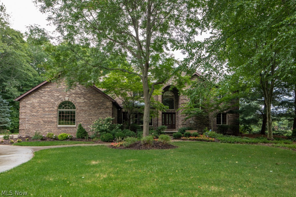 Welcome to 1229 River Woods Dr.! Nestled in the highly coveted River Woods subdivision, this massive solid brick colonial is situated on a private wooded 2.5 acres. Heading in through the front door, a grand entrance awaits featuring the two story foyer, handsome stairwell/balcony, and gleaming hardwood flooring which sprawls throughout the first level. The massive two story great room that is ideal for entertaining leads into the stately study, alongside a peaceful office. For a formal gathering, the dining room is an optimal space. The custom kitchen provides an abundance of solid cabinetry/granite countertop space, and an eat-in area w/ bay window overlooking majestic backyard views. Just off of the kitchen is a cozy, yet large family room, encased with windows filling the space gently w/ natural light. Heading upstairs you will find 4 bedrooms, bonus room. The owner's suite features a large en-suite, balcony views of both the backyard & great room. Serenity is provided in the flat