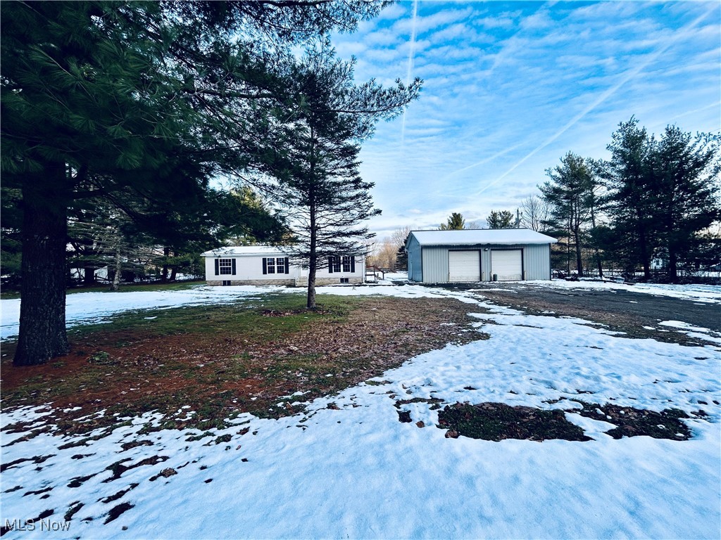 Big lot, big garage, big possibilities. This 3 bedroom 2 bath home serves up space and functionality in all the right ways. If wide-open space and a dream garage are on your wish list, consider it granted! 

Inside, you'll find an open and airy living area with vaulted ceilings that instantly make the home feel spacious and inviting. The heart of the home connects seamlessly to the kitchen where the stove and refrigerator stay. Washer and dryer to also stay making move-in day a breeze. The primary suite is your own private retreat, featuring a full en-suite bathroom and dual closets, offering both comfort and privacy. Two additional bedrooms and another full bath provide plenty of space for family, guests, or a home office. Appreciate the ease of single floor living and enjoy the comfort of central air when those dog-days of Ohio heat roll in. 

Outside, the property shines with a huge detached 32x40 heated garage boasting a 12 foot ceiling, 2 -10x10 garage doors, 50 amp service and a 220 hook up. With over 2 acres on a corner lot there's room to spread out, garden, explore, and enjoy the privacy of country living.