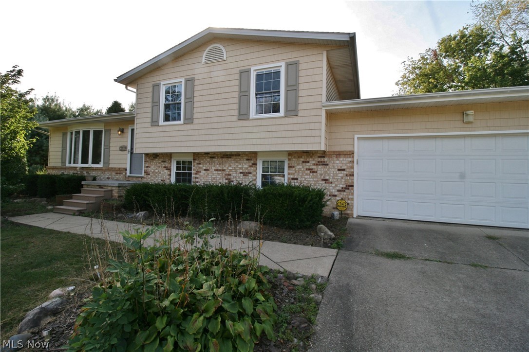 Fantastic split level for sale in Green! Convenient location for any commute. 4bed/2bath home with updated vinyl exterior. Huge detached garage with oversized door, 36'x30'. Large deck overlooking private backyard. Updated bathrooms with ceramic tile, new flooring throughout home, freshly painted, newer hot water tank, new electric panel - ready for moving in. Appliances stay. Comes with 1 year home warranty for peace of mind. For a private showing, call today!
