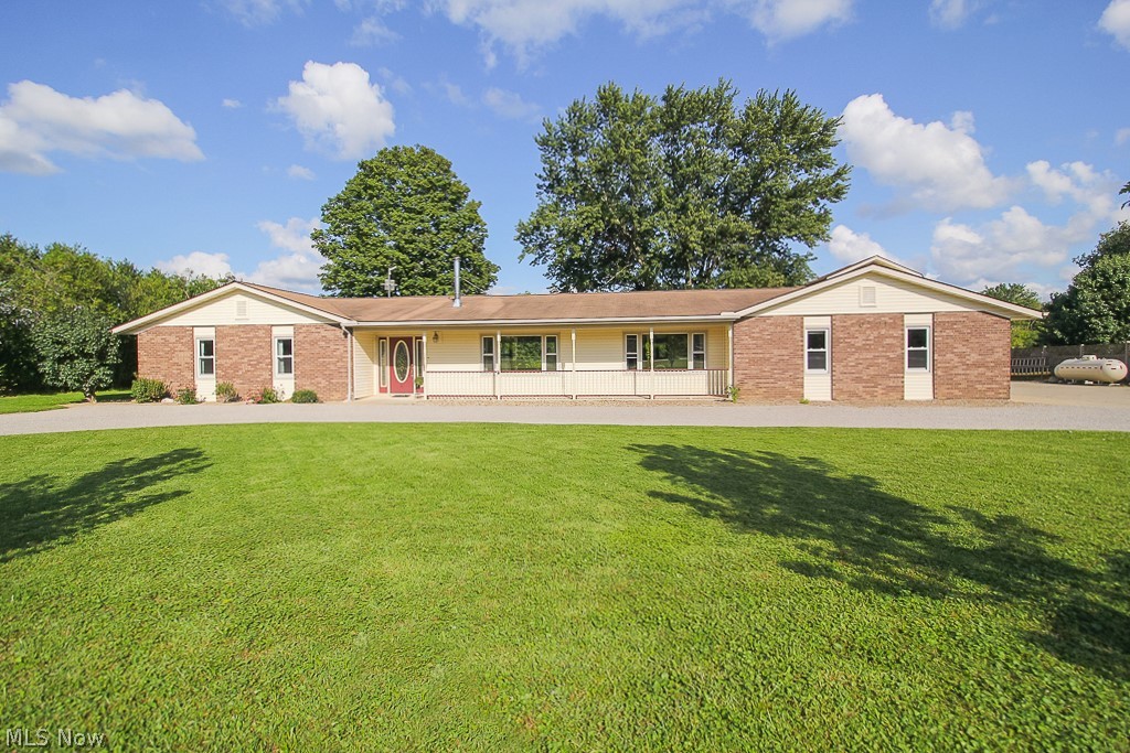 Dreaming of Country Living? This 5 bedroom 3 full Bath Sprawling Ranch on Over 5 Acres awaits! This home features Tons of curb appeal with a country front porch, plenty of parking in the horse shoe driveway and extra parking on the side concrete pad. Spacious and open, this 2800 sq ft. Classic Ranch is ideal for those seeking clean sightlines and a bright and airy feel. 5 generously sized bedrooms, and master has newer carpeting and an ensuite! Two Bedrooms are currently open to one another, with a bathroom close by, making a great set-up for a possible in-law or teen suite! Other Recent updates include Wood Laminate flooring throughout living and dining areas, soothing gray Wood look ceramic tile in the kitchen and hall. Ample laundry room with tons of storage! Huge covered Back porch with concrete patio and concrete firepit area added in 2019. The Back Yard is partially fenced with 2 Large sheds and a Huge heated and insulated 2 story Barn! The classic Barn has room for parking, work