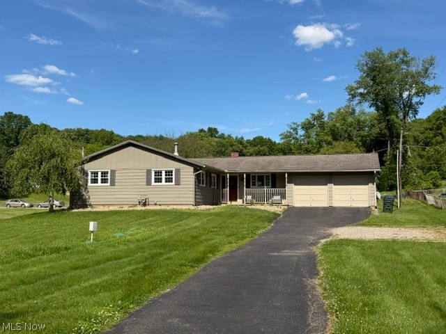 Great location just right on the edge of town! This nicely updated ranch home is nestled on a spacious .71-acre level lot. There are 3 bedrooms, 2 full baths, a full partially finished basement, and a 2-car attached garage. The inviting living space features a stunning two-sided stone wood-burning fireplace, perfect for cozy evenings and adding warmth and character to multiple rooms. The kitchen has rustic wood-beamed ceilings, a large center island, and a bright dining area highlighted by a bay window. There is a spacious master suite complete with a walk-in closet and a remodeled private bath. There are patio doors off the living room that lead out to a back deck that overlooks the large back yard, part that is fenced in for dogs. The basement has a laundry area, plenty of storage and room to finish for additional square feet if needed. For added peace of mind, a Generac whole-house generator is already in place and will remain with the home. There is all new LVP flooring, newer windows, updated electric, and a new septic that was installed in 2024. This home offers peaceful country living just minutes to town!