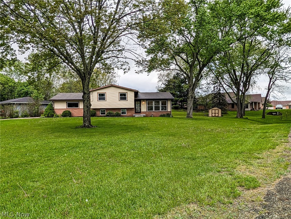 WOW, WOW, WOW, WOW WOW. Sitting peacefully on a large private lot, this is a split level like no other. This could be a great place for multi generational living or a great family home. Master craftsman has renovated this home. NO detail has been missed. 3 bedrooms and 3 full bathrooms, 2 full kitchens and 2 laundry rooms doesn't begin to tell the story of this home. Welcome your guests onto the front porch through the new custom door and your experience begins. Vaulted ceilings, engineered hardwood floors , custom wood beam and beautiful lighting. All new kitchen with custom soft close cabinetry, stainless steel appliances, quartz counters and a center island with bar seating. Designed for under counter microwave and beverage fridge. Open living experience with the living room, dining room and kitchen. Flooded with natural light this is a great space for entertaining. Up just a few stairs are 2 bedrooms and 2 full bathrooms. The Master suite also offers vaulted ceilings, walk in closet and a large and custom master bath with custom tiled shower large enough to share, and his and her sinks. A 2nd level laundry room offers maximum convenience. Down a few steps is the lower level family/living room with direct access to a concrete patio. A full kitchen and another full bathroom finish off this level. Down 1 more level to the 3rd bedroom (with egress window),offering custom beam woodworking and a walk in closet. Another full laundry and additional storage complete this level. The garage is also pretty special. 8' high x 18' wide new garage door with opener. New drywall and paint and a gorgeous epoxy floor. Most plumbing is New, NEW Furnace 2025. NEW tankless HWT 2024, NEW 150 electrical service including meter, meter base and connection, exterior walls have all been reinsulated. Nothing to do but move in and enjoy!