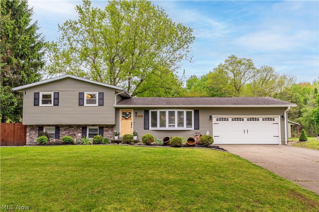 Welcome home to this beautifully updated 4-bedroom, 2 full bathroom on a spacious 0.69-acre lot in desirable Plain Township. This renovated open-concept main level features gleaming wood flooring, abundant natural light, quartz countertops, stainless steel appliances, a center island, and a cozy gas fireplace—perfect for everyday living and entertaining. The split-level design offers natural separation between living areas, bedrooms, and a private lower-level retreat. The fully finished lower level offers a versatile private retreat, currently set up as a primary suite with a renovated full bath, walk-in closet, laundry access. This flexible space can be easily used as office, gym, family room, recreation room, or a blend of all of the above! A standout feature is the exceptional garage(s) and storage capacity. In addition to the attached heated 2-car garage, there’s a massive heated detached flex building (approx. 35.8’ x 23.5’ / 841 sq ft) plus a separate utility shed—ideal for extra parking, workshop, hobbies, or customization. Combined, you get heated 4-car enclosed capacity. Outside, enjoy a large elevated deck with covered seating, a custom brick wood-burning fireplace (will convey), grilling space, and an all-season hot tub (will convey) with dedicated power. Updates include a new furnace, central air, hot water tank, water filtration system, and generator-ready electrical. Recent upgrades: new garage opener, thermostat, sliding door hardware, 2023 appliances (microwave, dishwasher, disposal), Ethernet wiring, and a Ring camera. Conveniently located near Al Leno Park, shopping, dining, Belden Village, and The Strip. There is even a walking path right along the tree line! This rare property offers expansive outdoor space, flexible living areas, and outstanding utility in one impressive package. Sellers will be offering a one year home warranty throgh America's Preffered Home Warranty!