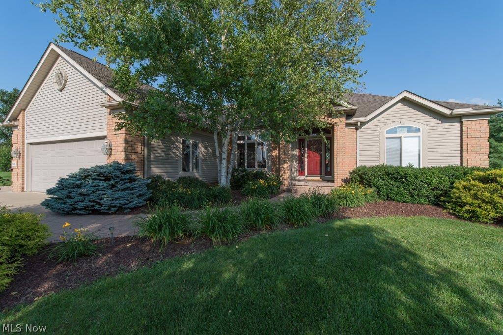 Stunning custom built home on a fantastic and private lot!!! This 3 bedroom, 2 full bath, 2,500 square foot split bedroom design ranch home sits on almost an acre lot with one of the nicest backyards you can find!! A beautiful covered deck has a sunken hot tub and can be accessed off the dinette and the master bedroom. A large concrete patio leads to a stunning pond with waterfall. Fully private yard...a fabulous retreat! This home has an open and flowing floor plan that is sure to please. Huge 3 car garage that is heated. Large kitchen with ceramic tile floors, new granite countertops, tile backsplash, pantry and new sink and faucet. Small office area right off the kitchen that is very useful! Large great room with vaulted ceilings and 3 way gas fireplace. Formal dining room and large dinette area. Master has a walk in closet, corner soaking tub and skylights for open feel! Large 12 course basement that is plumbed for a full bath and a bar. Quality built home with solid 6 panel doors,