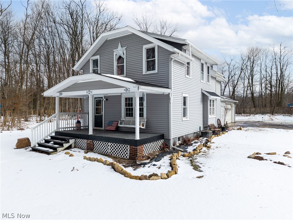 There are homes… and then there are properties that change the way you live. Welcome to nearly 5 fully fenced acres designed for freedom, functionality, and peaceful living — all just five minutes from I-71 and close to Route 42. As the automatic gate opens and you pull down the drive, the world feels quieter. The entire 4.62 acres is enclosed with a 6-foot treated privacy fence set on concrete posts, creating a secure and secluded setting for animals, recreation, and everyday life. The farmhouse greets you with a timeless front porch and porch swing — the perfect place for morning coffee or evenings overlooking your quarter-acre stocked pond filled with bass, bluegill, and catfish. Mature trees and an apple tree add beauty and shade to the landscape. Inside, newer tongue-and-groove wood flooring runs throughout the main level. A professionally removed wall opens the kitchen to the dining area, creating a bright, connected gathering space ideal for entertaining. Custom bench seating adds warmth and functionality. Just off the attached two-car garage, a thoughtfully designed mudroom addition with a full bath makes country living practical — perfect after time in the shop or outdoors. Upstairs features four spacious bedrooms and a remodeled full bath. Newer vinyl flooring in the primary bedroom and bath reflects continued updates. Major improvements include a new roof and gutters (2022) and a furnace installed in 2026, offering peace of mind. The impressive 48’ x 42’ shop includes 10-foot tall and 12 foot wide fully insulated doors, separate 220 electric and plumbing, a bathroom, 6-inch concrete floors, 2 floor drains— ideal for a business, workshop, storage, or homesteading expansion. A chicken coop, livestock pen, and space to grow complete the property. This isn’t just acreage. It’s a lifestyle — private, functional, and ready for its next chapter.