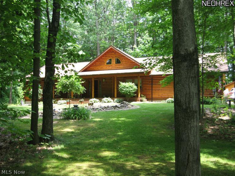 MOTIVATED SELLER - Nestled in the woods - Impressive log home sits on 1.71 acres. Enjoy the relaxing front porch (40 x 8), back to nature. Inside a large great room welcomes you, unbelievable cathedral ceiling.  Kitchen includes stainless appliances, dining area, living area & gas fireplace. 1st floor master bedroom & full bath with jetted soaking tub. 2 extra bedrooms, one being used as an office/craft room, 1st floor laundry & full main bath. Basement can be customized to your liking. Extra-large garage can accommodate 3 cars. Security system,"Rinna (hot Water) Instantance" plus A O Smith hot water tank for back up & water softener. Public sewers. Adorable log play house, stamped patio (48 x 12) & log shed. This home has so much to offer if you are looking for a peaceful relaxing location. When the leaves are on the trees this home & setting is very private. HOME WARRANTY INCLUDED.