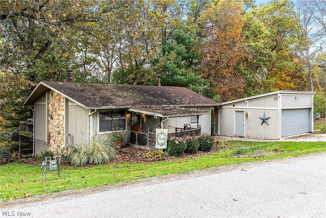 Nestled in the trees, & located in the Warren School district, sits this quaint cabin-like home, ready for new owners.  With 3 bedrooms, 2 full bathrooms, an open concept first floor, & a full finished walk-out basement, this home is roomier than it appears from the road. Outdoor features include: covered front porch, open back deck off of the kitchen, covered back deck, additional covered lower deck, fire pit area, additional parking pad, and an oversized one-car detached garage. Situated on a 1-acre wooded lot, on a dead-end street, there is peace & quiet to enjoy here both inside & outside.