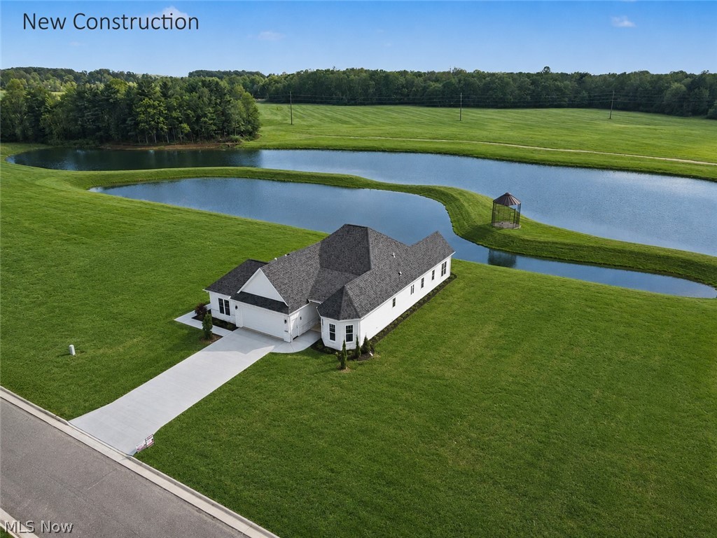 YOUR WATERFRONT SANCTUARY AWAITS.
Enter refined LUXURY & ELEGANCE in this meticulously crafted single-story water front residence with planned amenities for 2 PICKLEBALL COURTS, POOL & CLUBHOUSE & WALKING TRAIL around the back lake . The exterior features a blend of natural stone, curated cladding, and dimensional tile for added depth and architectural interest. Premium Pella windows and exterior doors frame unobstructed water views, capturing both sunrises and sunsets. A serene white palette complements the natural setting with a beautiful step free ranch home featuring a single level living, wide open spaces, and a mobility friendly layout designed for comfort, safety, and convenience!

Inside, 10-foot ceilings and 8-foot solid wood custom doors create a grand feel. Walls of sliding glass doors open to a concrete patio overlooking the water, seamlessly blending indoor and outdoor living. Specialty lighting enhances architectural detail throughout.

The chef’s kitchen offers 20 feet of specialty Arabian Leather Granite Countertops, Amish-Crafted Cabinetry, and a large center island with seating for 5–6.  A full scullery-style pantry with prep sink adds function and style. The living area is anchored by a stunning fireplace with custom stone and handcrafted Amish wood cladding.

Flexible spaces include a front bonus room with private exterior entrance—ideal for office, gym, or studio—and a vaulted steeple-style bonus room suited for a retreat, guest suite, or media room. The owner’s suite features a custom tiled bath, quartz counters, and an oversized walk-in closet.

Guest bedrooms, powder room, and pantry include Amish cabinetry with granite tops. The laundry room is spacious with cabinetry and approx. 6 ft of counter space.

Thoughtful design, high-end finishes, and custom craftsmanship define this waterfront home, offering luxury, versatility, and exceptional living for both relaxation and entertaining.
Home builder is FJA Developers/Frank Amedia.