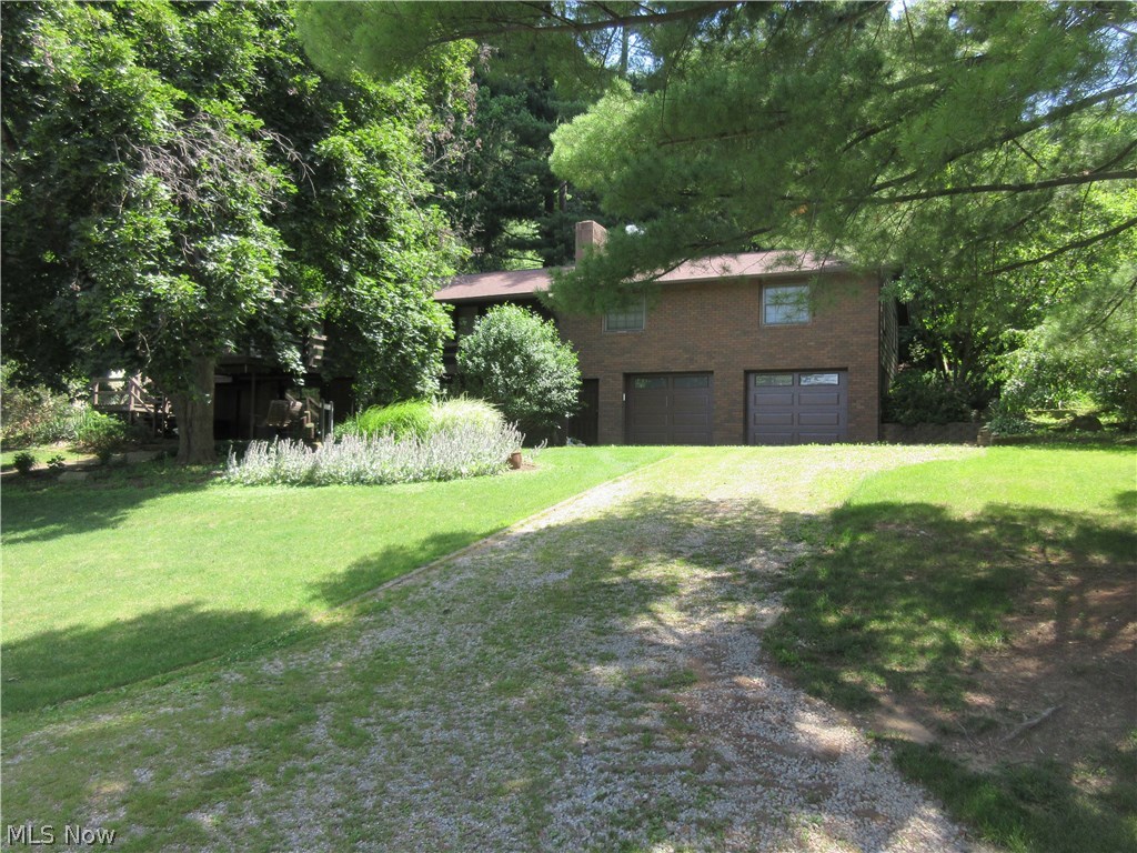 Scenic views of the lake from this 3-4 bedroom, 2 bath home. Fireplace in the living room with triple glass doors. Custom oak kitchen with breakfast bar includes a lighted pie cabinet and instant hot water dispenser. Kitchen appliances are included.  Formal dining room with access to the 14 X 14 covered brick patio. First floor laundry. Brick fireplace in the master bedroom with walk in closet. Sitting room on the second floor is potential fourth bedroom. Large hobby/game/bunk room with new vinyl thermo windows. Walk up attic. 2.5 car attached garage with workbench. 10 X 14 storage barn with electric. New roof in 2006. New dock with boat lift. Only 100+/- ft from the water. Turn key with some furnishings negotiable.  MWCD lease fee is $1,654.00 for 2017. Lot# T-65.