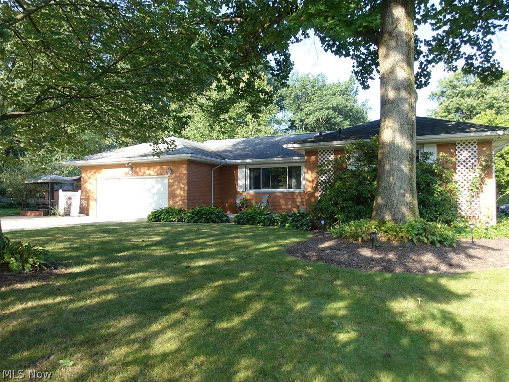 Spacious all brick ranch in Tallmadge!  Lovely property features spacious living room with gas fireplace, crown molding & recessed lighting.  The dining room also has crown molding and is open to the living room so it is perfect for entertaining.   All bedrooms have hardwood flooring and nice closet space.  The master offers an updated full bath with walk in shower (2016).  A second full bath features double vanity and jetted tub.  The applianced kitchen provides for plenty of cabinet and counter space, recessed lighting & has a pantry with pull out drawers.  There's a nice sunroom with lots of windows for natural light and access to the side patio and beautiful yard.  The lower level is amazing and offers a recreation room, separate room perfect for an office/bonus room plus a full bath with walk in shower AND has glass block windows.  You will love the outside to relax by the fire pit, and side patio.  Some updates include: Furnace/AC - 2014; windows - 2006; roof - 2001 (35 yr shingl