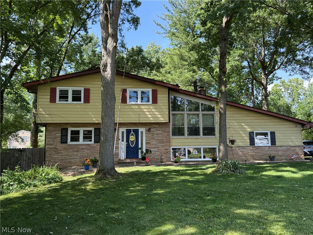 Welcome home to this beautifully updated 4-bedroom split-level Colonial situated on a spacious, fully fenced .52-acre lot in Northfield. Offering the perfect blend of timeless character and modern updates, this move-in ready home provides exceptional indoor and outdoor living space.

The inviting curb appeal begins with a brand-new front entry door leading into a warm and welcoming interior. The remodeled kitchen is the heart of the home, featuring quality Riceland cabinetry, granite countertops, a center island and stylish tile backsplash,  The spacious dining room offers plenty of room for holiday gatherings and special occasions. Additionally on the Main level is a BONUS ROOM currently being used as an Exercise area, The half bath is conveniently located on the main level as well.  Just a few steps up and you are in the impressive Great Room which showcases a cozy wood-burning fireplace and dramatic vaulted walls of windows that flood the space with natural light while providing beautiful views of the front yard and the backyard.  The Bedrooms are all located on level 3 with newly refinished hardwood floors and ceiling fans.  The main Bathroom is also on level 3. Outside, enjoy the expansive, completely fenced backyard with ample room for pets, play, gardening, or future outdoor entertaining. A covered Patio is a plus for enjoying the outdoors. Built in 1960 and thoughtfully maintained and updated throughout, this home combines classic craftsmanship with today's most desired amenities.


Additional highlights include an attached, back loading 2 car garage and an Ohio State Waterproofing system with a lifetime transferable warranty, offering peace of mind for years to come. Conveniently located near shopping, dining, parks, schools, and major highways, this exceptional Northfield property is ready for its next owner. Don't miss the opportunity to make this beautifully updated home your own!