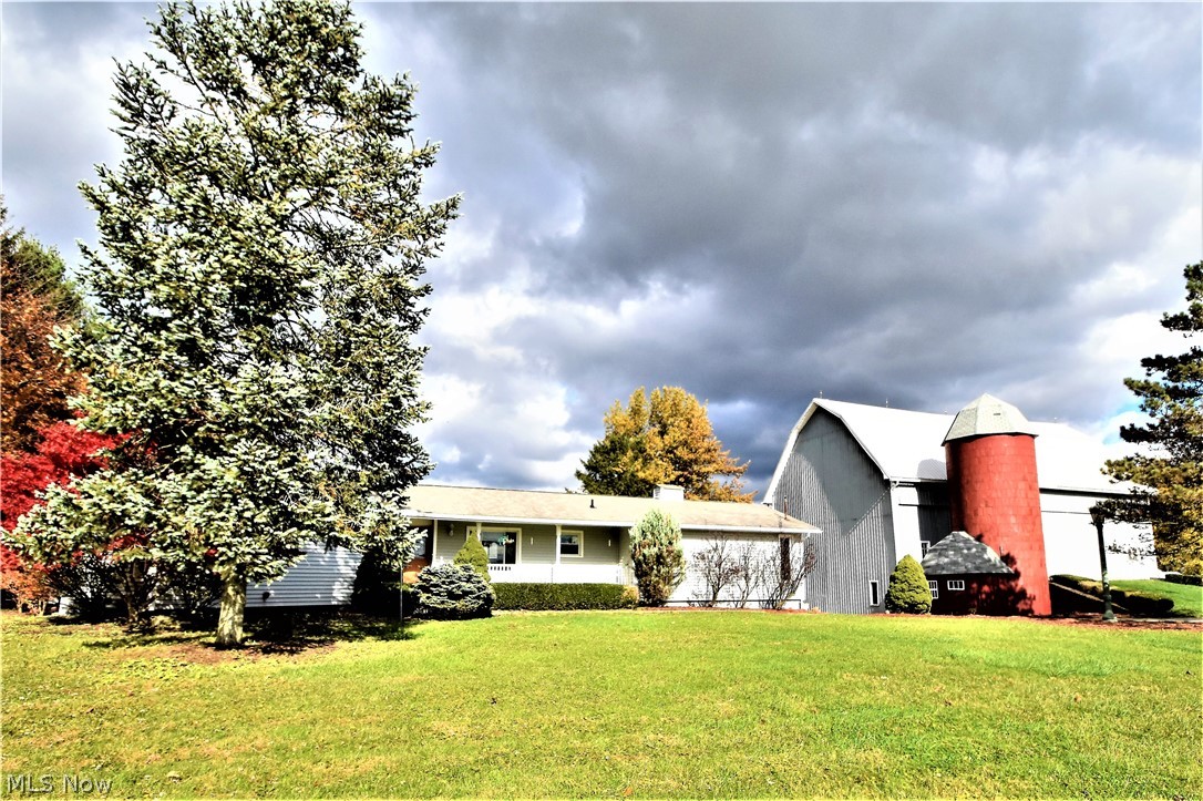 This 7.99-acre property includes two parcels, a custom-built ranch with fresh paint and updated flooring, a "10,000 baler" bank barn, a pond, wooded setting with pastures and cross-fencing in the back, and plenty of peaceful, open space. The ranch home has ample storage, a heated attached garage, and a large, remodeled lower level with a wood-burning stove for added comfort.The kitchen and dining room are spacious with a cathedral ceiling. The large back deck is TimberTech® and includes a gazebo. The elegant 1906 bank barn and the 1920 silo have a wonderful history with milking cows, storing hay and vintage cars, and hosting barn parties. The barn has metal roofing and siding for many more years of service. Several lean-tos have natural flooring for livestock. Three pastures were cross-fenced in preparation for sheep and the potential to apply for a CAUV tax discount. Quick, easy access to I-71, I-271 and I-77. Seller is providing a one-year home warranty.